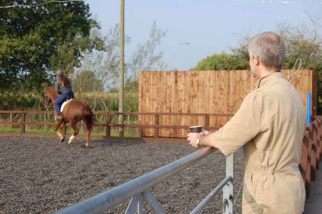 veterinarian watching horse under saddle